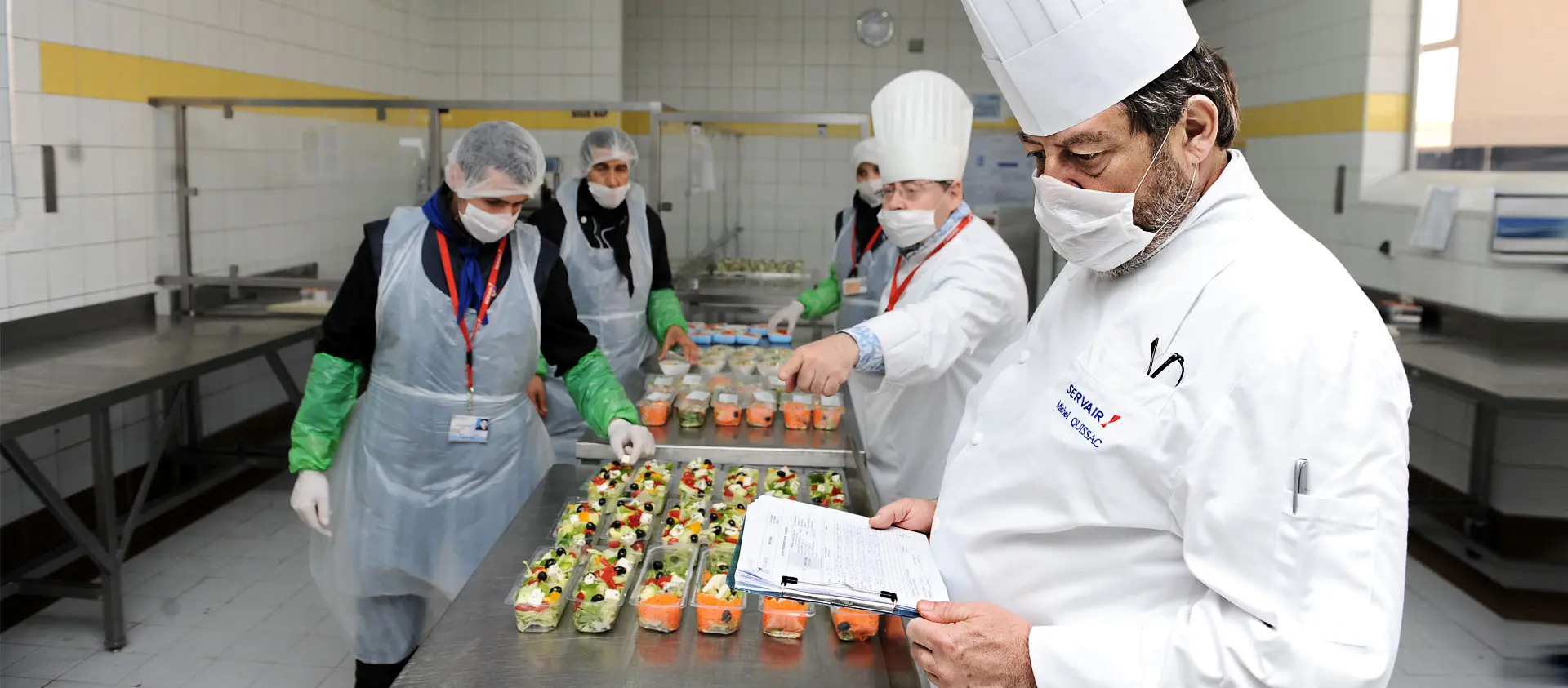 Team in the kitchen preparing dishes and checking food production