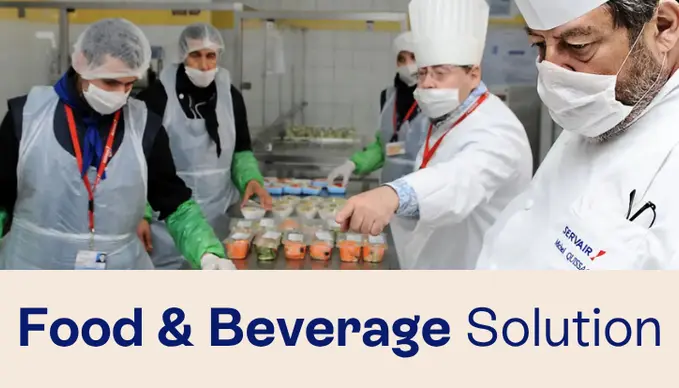 Chefs in a kitchen using an ERP for food and beverage management.
